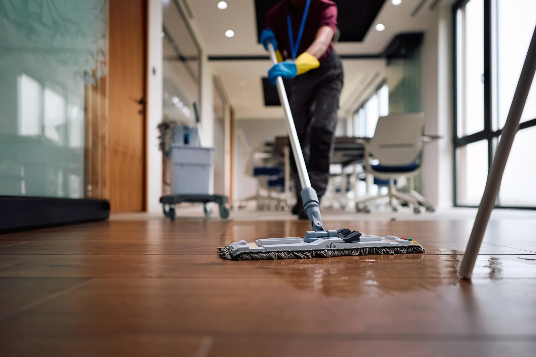 Commercial cleaning specialist mopping an interior floor